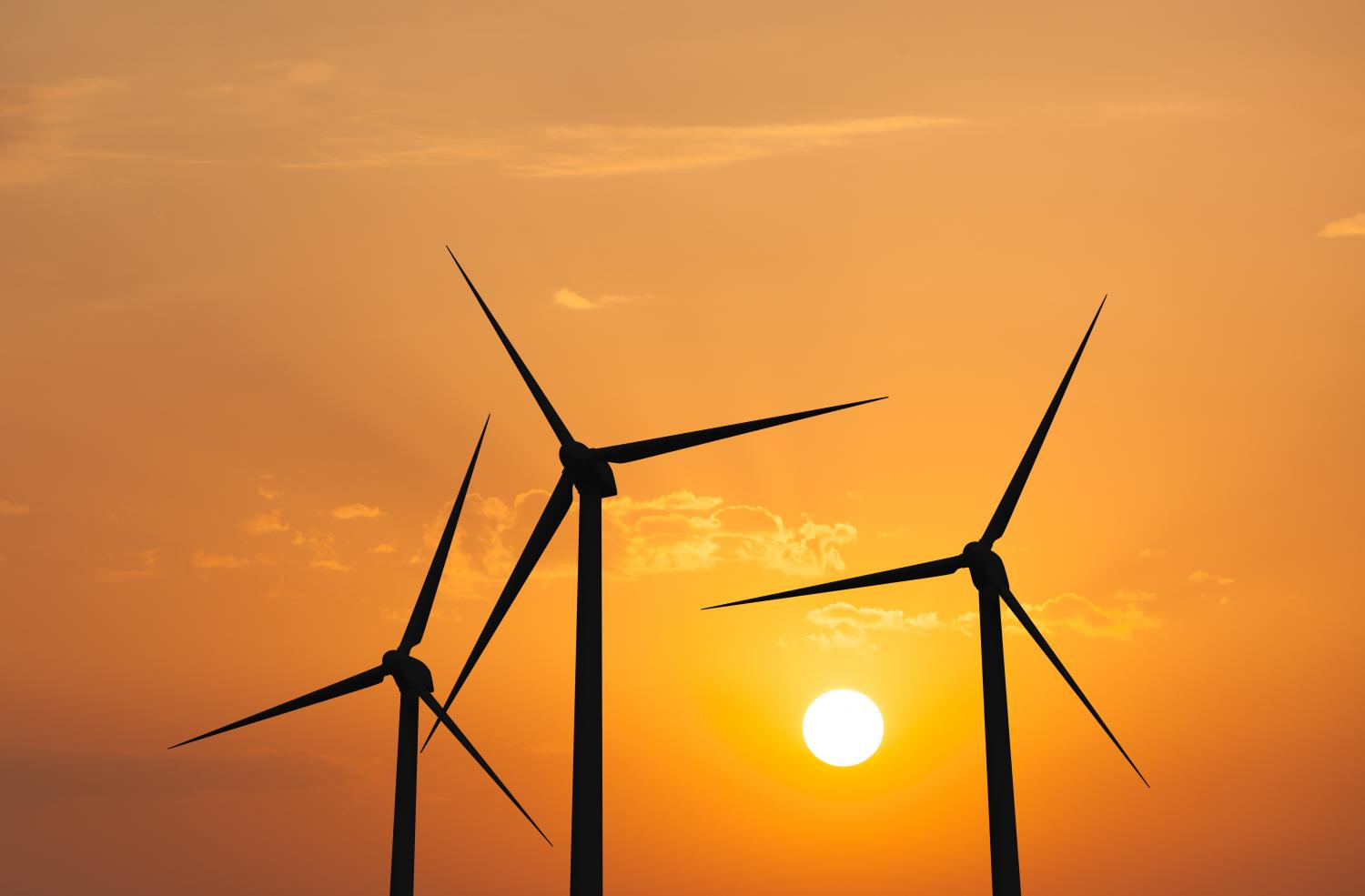 Wind generator turbines in sky Green renewable energy concept - wind generator turbines in sky on sunset